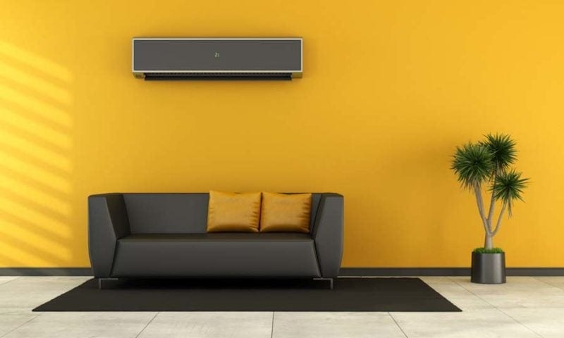 Modern living room with black couch and ductless air conditioner on wall - rendering