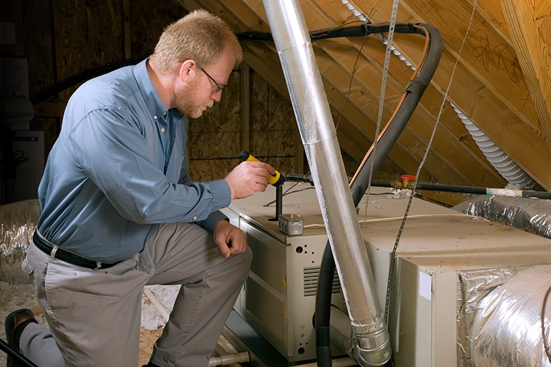 What Are the Different Types of Furnaces? - Man Repairing Furnace.