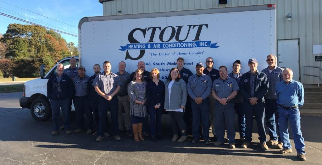 Stout Heating and Air Conditioning team standing in front of service truck.