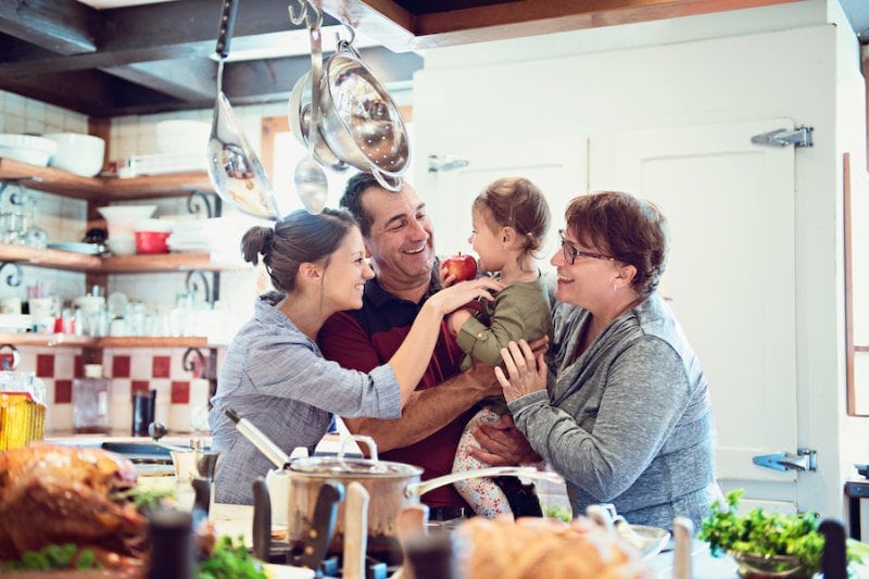 Family inside making cookies.