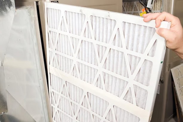 Changing out furnace filter.